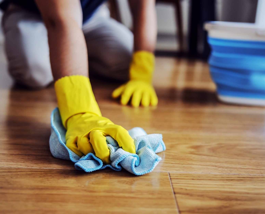 Close up of man waxing parquet