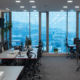 Side view of multiple computer desks in commercial office space