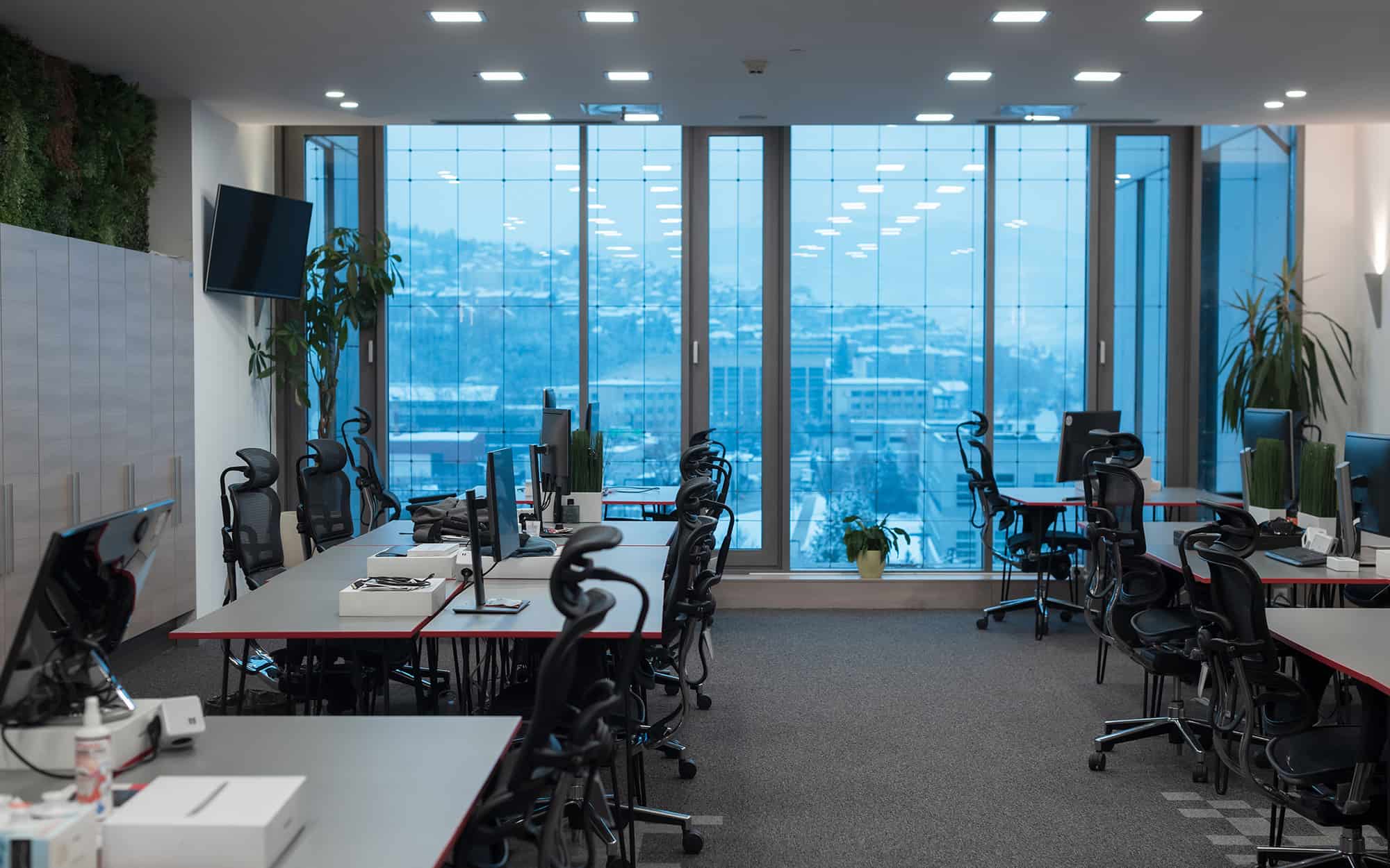 Side view of multiple computer desks in commercial office space