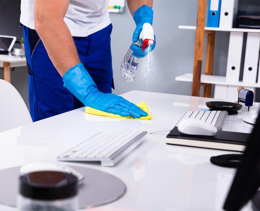 Worker cleaning office desk