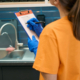 Cleaning company worker checking list cleaned areas in coworking space