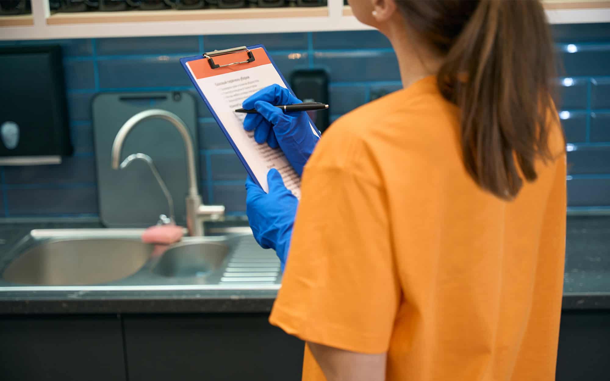 Cleaning company worker checking list cleaned areas in coworking space