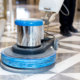man polishing marble floor in modern office building